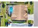 Aerial view of a home with a screened pool, well-manicured lawn, and a traditional roof at 4585 Dover Street E Cir, Bradenton, FL 34203
