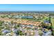 Beautiful aerial view showcasing a community with a lake, golf course, and tile-roofed homes at 4585 Dover Street E Cir, Bradenton, FL 34203