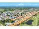 Wide aerial shot of a planned community featuring well-kept lawns, mature trees, and a tranquil pond at 4585 Dover Street E Cir, Bradenton, FL 34203