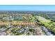 Expansive aerial view of a neighborhood with multiple ponds, a golf course, and well-maintained landscaping at 4585 Dover Street E Cir, Bradenton, FL 34203