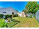 Backyard with green lawn, white fence, shed, and lush landscaping at 4585 Dover Street E Cir, Bradenton, FL 34203