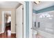 Bright bathroom featuring a tiled shower and tub, and a frosted glass window at 4585 Dover Street E Cir, Bradenton, FL 34203