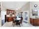Bright breakfast nook features a pool view, granite counters, custom cabinetry, and a wine rack at 4585 Dover Street E Cir, Bradenton, FL 34203