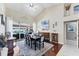 Open dining room with hardwood floors, high ceilings, and a sliding door to the outdoor pool area at 4585 Dover Street E Cir, Bradenton, FL 34203
