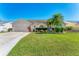 Well-maintained single-story home with lush green lawn, mature landscaping, and an attached garage at 4585 Dover Street E Cir, Bradenton, FL 34203