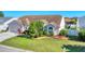 Landscaped front yard with palm trees and a well-maintained lawn enhances the curb appeal of this home at 4585 Dover Street E Cir, Bradenton, FL 34203