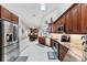 Gourmet kitchen with stainless appliances, generous counter space, and an open view to the dining area at 4585 Dover Street E Cir, Bradenton, FL 34203
