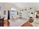 Spacious living room features high ceilings, hardwood floors, a neutral color palette, and lots of natural light at 4585 Dover Street E Cir, Bradenton, FL 34203