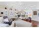 Open-concept living room featuring hardwood floors, a vaulted ceiling, and lots of comfortable seating at 4585 Dover Street E Cir, Bradenton, FL 34203