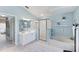 Light and bright main bathroom featuring a soaking tub, glass shower, and & vanities at 4585 Dover Street E Cir, Bradenton, FL 34203