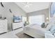 Relaxing main bedroom showcasing a vaulted ceiling, a king bed, and an oversized dresser with television at 4585 Dover Street E Cir, Bradenton, FL 34203