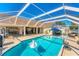 Sparkling pool with dolphin water feature, inflatable toy, and lounging area at 4585 Dover Street E Cir, Bradenton, FL 34203