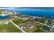 Spacious lot with a home featuring a screened pool in a beautiful waterfront community and lush greenery at 5365 Craig Ter, Port Charlotte, FL 33981