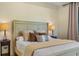 Comfortable bedroom featuring neutral tones, bedside lamps, and a decorative headboard at 5365 Craig Ter, Port Charlotte, FL 33981
