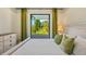 Bright bedroom features a door leading to an outdoor patio with views of the lush greenery at 5365 Craig Ter, Port Charlotte, FL 33981