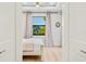 Bright bedroom featuring wood floors, a ceiling fan, and a window view at 5365 Craig Ter, Port Charlotte, FL 33981
