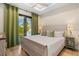Light bedroom featuring a view of the patio, light wood floors, and ceiling fan at 5365 Craig Ter, Port Charlotte, FL 33981
