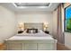 Bright bedroom featuring a tray ceiling, bedside lamps, and a large bed at 5365 Craig Ter, Port Charlotte, FL 33981
