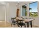 Dining area with modern chandelier and a view of the backyard through the large windows at 5365 Craig Ter, Port Charlotte, FL 33981