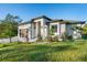 Contemporary one-story home with verdant lawn and minimalist landscaping, complemented by a two-car garage and a stylish entrance at 5365 Craig Ter, Port Charlotte, FL 33981
