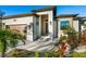 Attractive single-story home featuring a well-kept lawn, palm trees, and a modern facade with a two-car garage and inviting entryway at 5365 Craig Ter, Port Charlotte, FL 33981