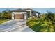 Inviting one-story home with a well-groomed lawn, a two-car garage, and elegant landscaping adding to its curb appeal at 5365 Craig Ter, Port Charlotte, FL 33981