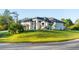 Beautiful single-story home with lush green lawn, well-maintained landscaping, and a stylish, modern design aesthetic at 5365 Craig Ter, Port Charlotte, FL 33981