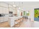 Bright, modern kitchen with white cabinetry, quartz countertops, stainless steel appliances, and adjacent dining area at 5365 Craig Ter, Port Charlotte, FL 33981