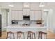 Contemporary kitchen with an island and seating, undermount sink, white cabinets, and stainless steel appliances at 5365 Craig Ter, Port Charlotte, FL 33981