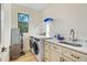 Laundry room with front loading washer/dryer and built-in sink at 5365 Craig Ter, Port Charlotte, FL 33981