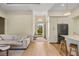 Bright living room showcasing hardwood floors, recessed lights, a cozy sofa, and a welcoming view of the front entrance at 5365 Craig Ter, Port Charlotte, FL 33981