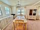 Inviting dining room with natural light, charming chandelier and a classic display cabinet at 5511 Denmark Dr, Bradenton, FL 34207