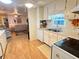 Well-lit kitchen with functional appliances and ample storage, flowing into the comfortable living area at 5511 Denmark Dr, Bradenton, FL 34207