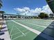 Outdoor shuffleboard courts with shelters, landscaping, and surrounding palm trees at 5511 Denmark Dr, Bradenton, FL 34207