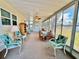 Bright sunroom with ample seating, ceiling fan, and large windows providing a tranquil view at 5511 Denmark Dr, Bradenton, FL 34207
