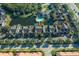 Aerial view of community featuring community pool, townhomes, and lake at 5681 Bidwell Pkwy # 104, Sarasota, FL 34233