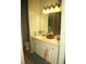 This bathroom features double sinks with white cabinets and a neutral color scheme at 5681 Bidwell Pkwy # 104, Sarasota, FL 34233
