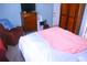 This cozy bedroom features a wooden dresser with a TV on top and a comfy-looking armchair at 5681 Bidwell Pkwy # 104, Sarasota, FL 34233