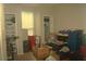 This cluttered bedroom has storage shelves and cardboard boxes at 5681 Bidwell Pkwy # 104, Sarasota, FL 34233