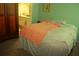 Comfortable bedroom features a bed, wardrobe, and a doorway to an adjoining bathroom at 5681 Bidwell Pkwy # 104, Sarasota, FL 34233