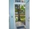 View from doorway to backyard featuring trees, pond, and fence at 5681 Bidwell Pkwy # 104, Sarasota, FL 34233