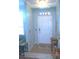 Bright foyer featuring tiled floor, overhead transom, and neutral color palette at 5681 Bidwell Pkwy # 104, Sarasota, FL 34233