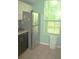 Kitchen featuring stainless steel refrigerator, dishwasher, and light blue walls at 5681 Bidwell Pkwy # 104, Sarasota, FL 34233