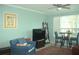 Inviting living room with comfortable seating, ceiling fan, and large windows at 5681 Bidwell Pkwy # 104, Sarasota, FL 34233