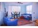 Cozy living room with plush seating and lots of natural light from two windows at 5681 Bidwell Pkwy # 104, Sarasota, FL 34233