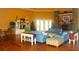 Spacious living room area features hardwood floors, plenty of seating, a fireplace, and charming decor at 5681 Bidwell Pkwy # 104, Sarasota, FL 34233