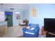 Open floor plan with living area featuring stylish decor, chair, and a television at 5681 Bidwell Pkwy # 104, Sarasota, FL 34233