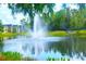 Pond with fountain overlooking colorful townhomes at 5681 Bidwell Pkwy # 104, Sarasota, FL 34233