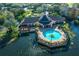 Aerial view of a clubhouse and pool on a pond at 5681 Bidwell Pkwy # 104, Sarasota, FL 34233