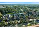 An aerial view of residences, a clubhouse with pool and pond at 5681 Bidwell Pkwy # 104, Sarasota, FL 34233